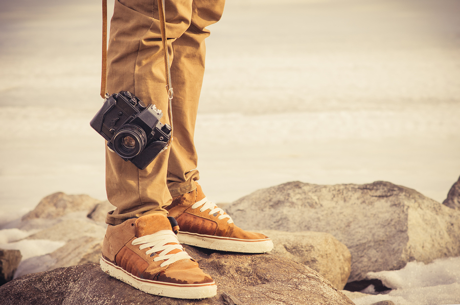Feet man and vintage retro photo camera outdoor Travel Lifestyle vacations concept ** Note: Shallow depth of field